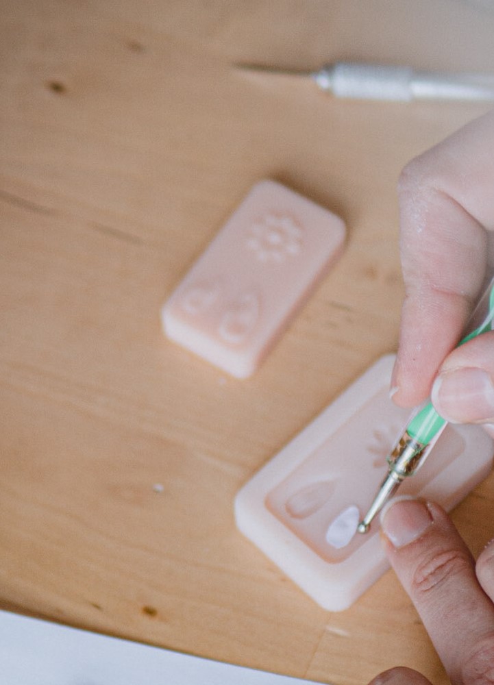 Hand detailing a silicone mold with a paintbrush