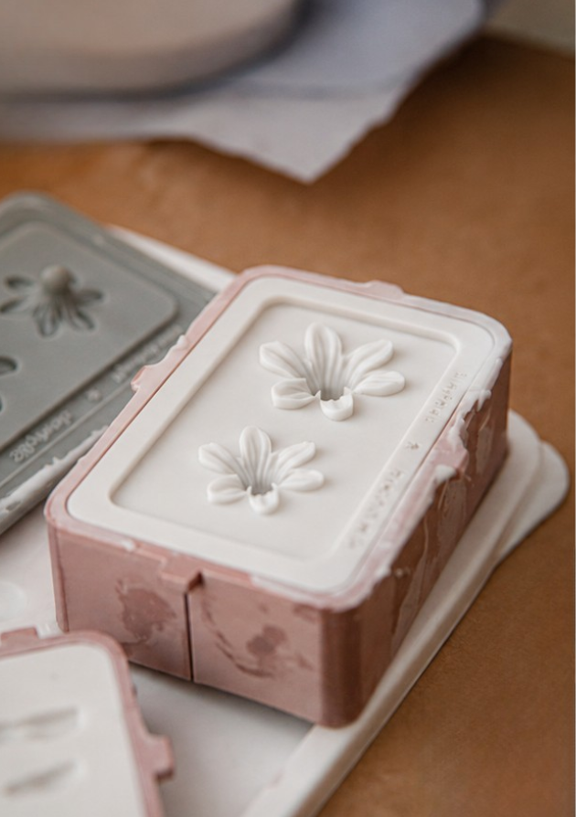Silicone mold showing daisy flower and leaf cavities